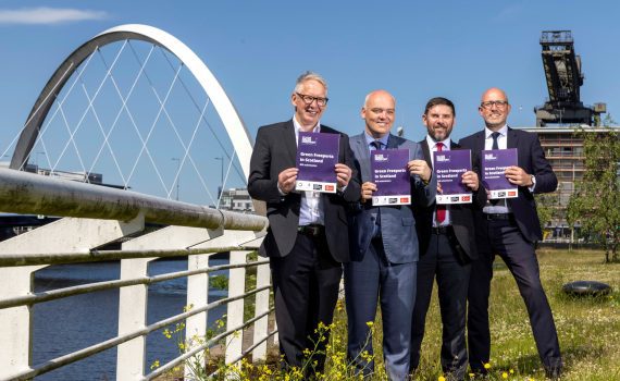 Kevin Rush, Ross Nimmo, James McSporran and Peter Stirling standing in front of the Clyde Arc holding the Clyde Green Freeport bid.