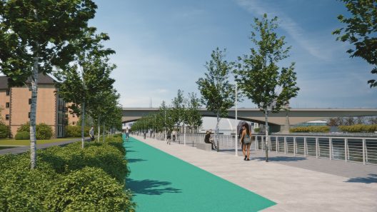 Artists' impression image of Windmillcroft Quay showing a large pedetrian route with a cycle path, seating along the edge of the path facing the river, and additional trees and other greenery.